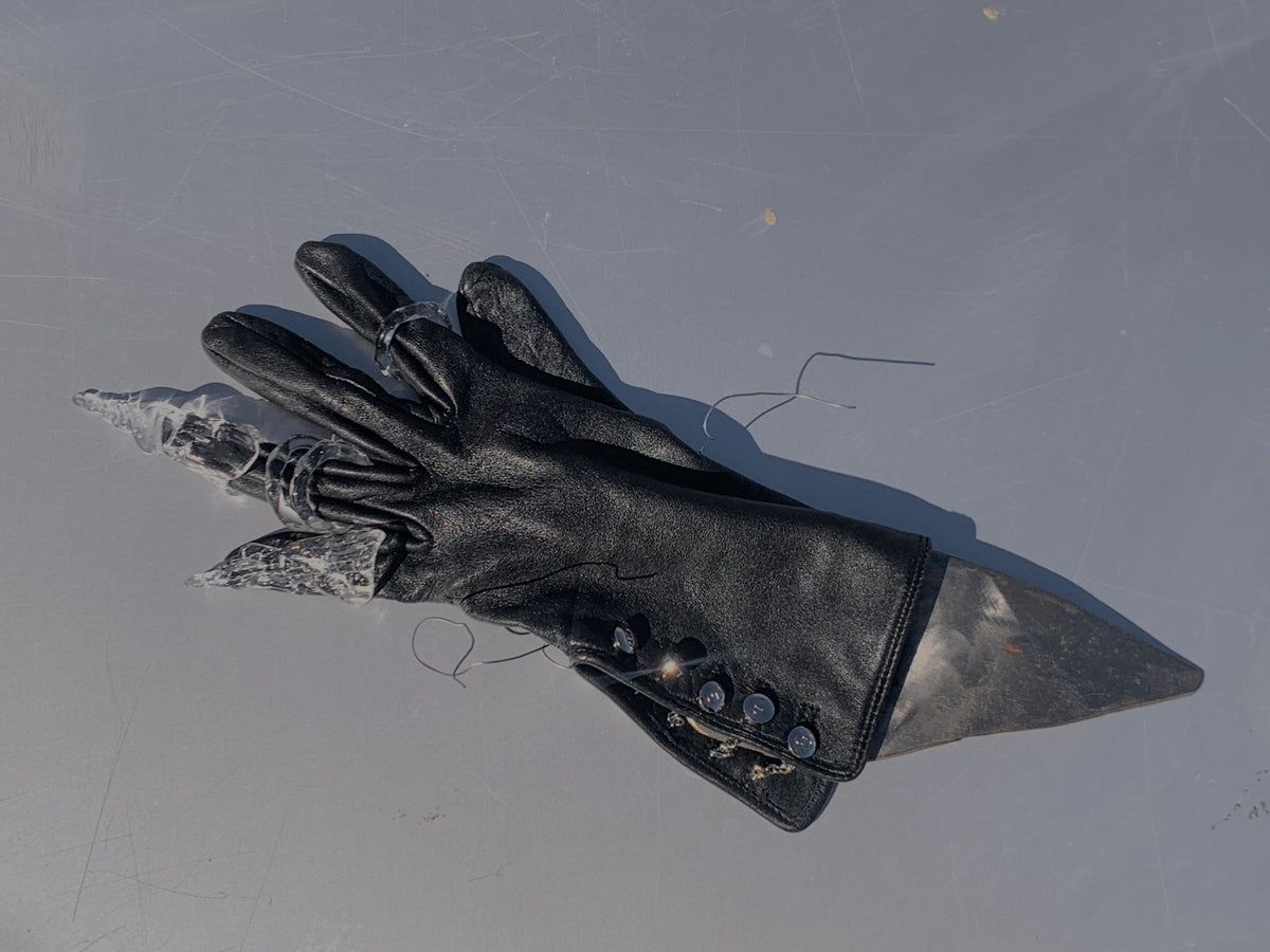 Claw Glass Ring 0139 in clear hand-sculpted borosilicate glass, worn over a black leather glove, Rain and Rivers