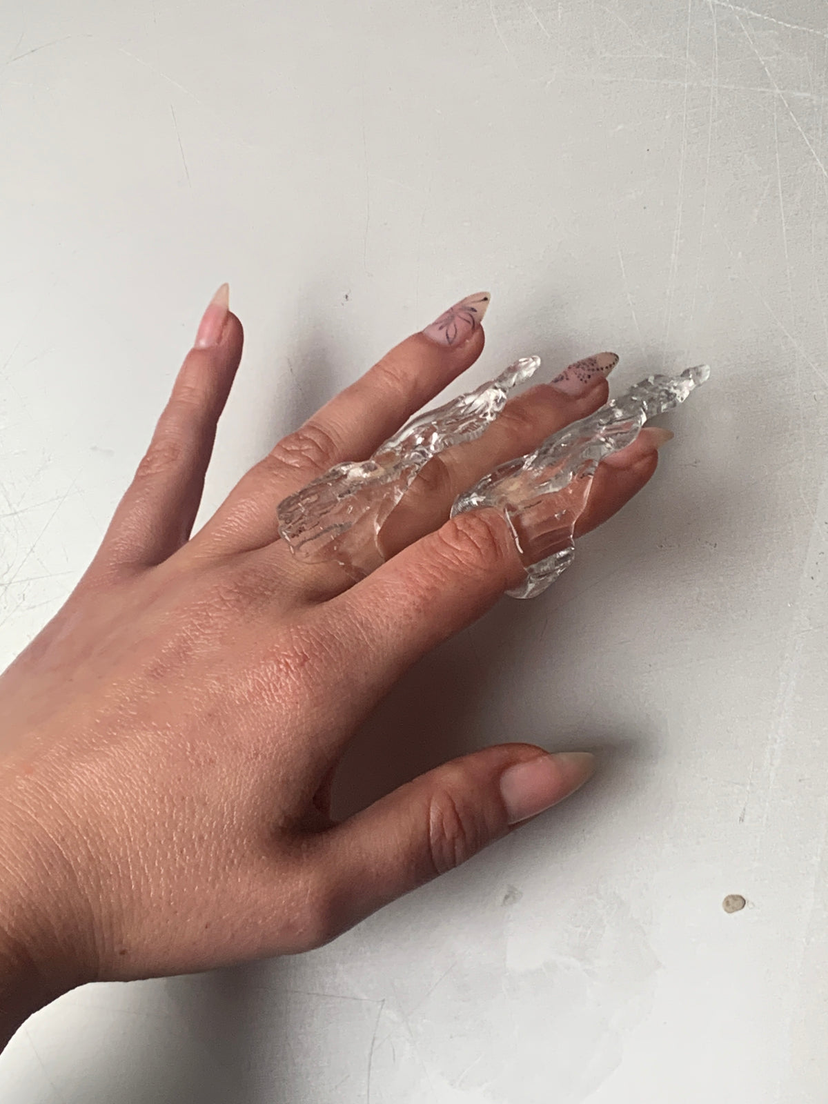 Claw Glass Ring 0139 in clear hand-sculpted borosilicate glass, worn on the hand, Rain and Rivers