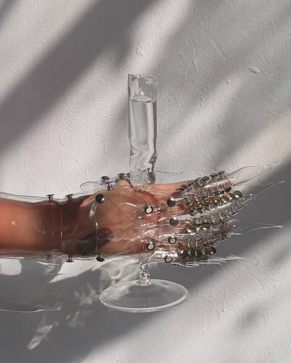 Glasses 0006 in clear hand-sculpted borosilicate glass, held in the hand, Rain and Rivers, Barcelona