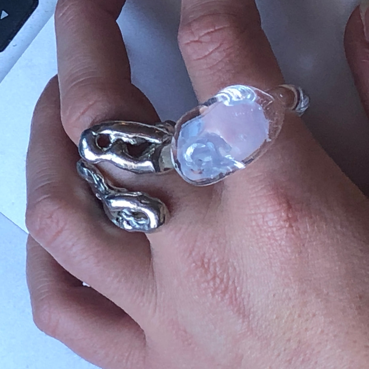 Chunky Signet Glass Ring 0108 in clear hand-sculpted borosilicate glass, close-up on the finger, Rain and Rivers