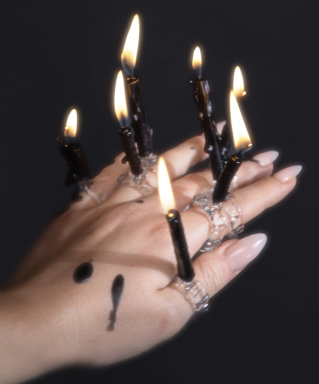 Candle and Flower Glass Ring 0136 in hand-sculpted borosilicate glass holding lit candles, worn on the hand, Rain and Rivers