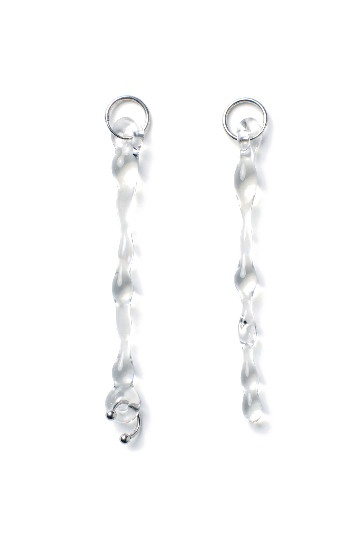 Rain and Rivers Drop Earrings 0004 – pair of long hand-sculpted clear borosilicate glass drop earrings on steel hoops, one with a stainless steel horseshoe piercing, handmade in Barcelona, product photo on white