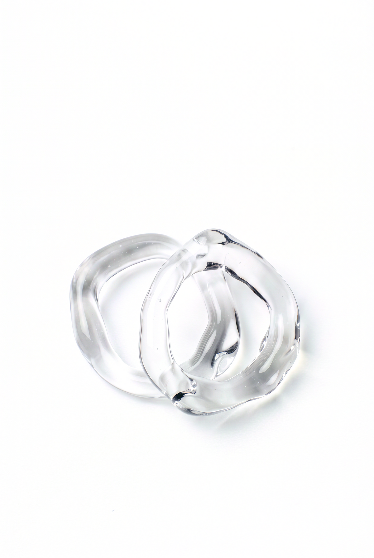 Rain and Rivers Stacking Glass Band Rings 0031 – two hand-sculpted clear borosilicate glass band rings, minimalist stackable glass jewelry handmade in Barcelona, product photo on white