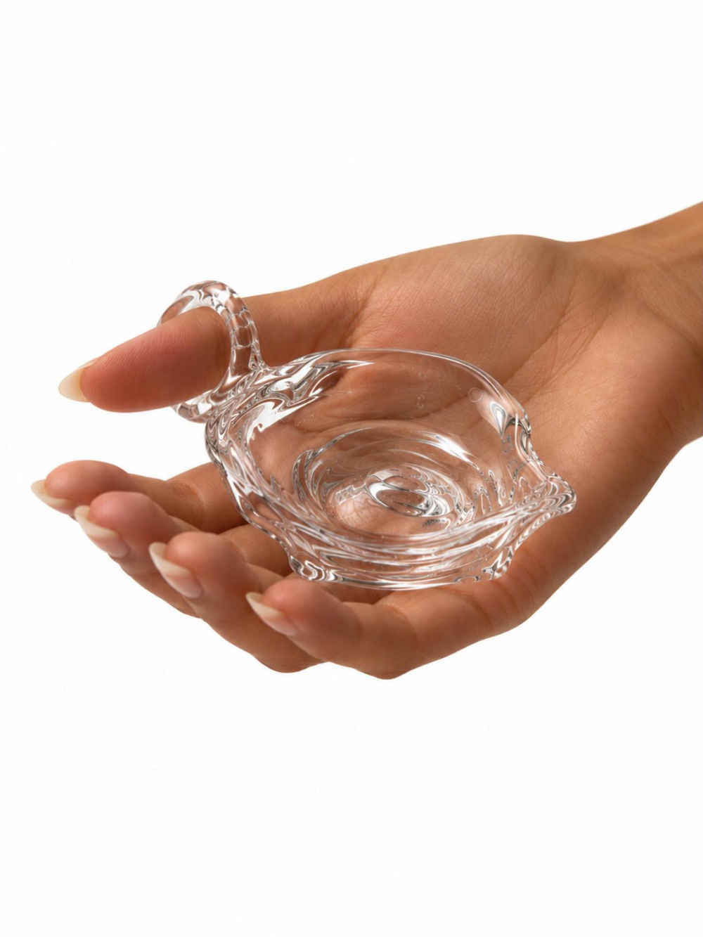 Ashtray 0001 by Rain and Rivers: a wearable handmade clear glass ashtray with a glass ring fused to its rim, worn on the finger while the dish rests in the palm, on a white background
