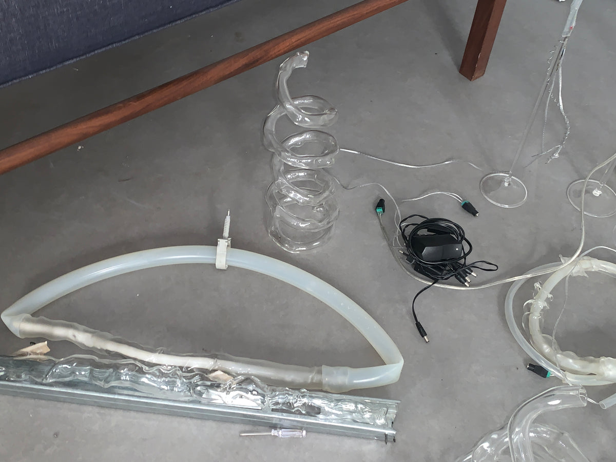 Blown glass coils and spirals with residual materials on the studio floor